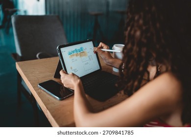 Tablet screen shows digital mind map as woman draws with stylus, representing active thinking, tech fluency, and organized freelance workflow through digital tools and focus.