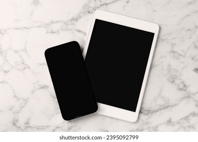 Tablet and smartphone with blank screens on white marble table, flat lay - Shutterstock ID 2395092799