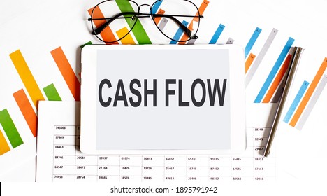 The Tablet With Text Cash Flow On The Business Charts,glasses And Pen