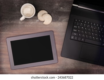 Tablet touch computer gadget on wooden table, vintage look
