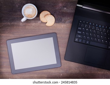 Tablet touch computer gadget on wooden table, vintage look