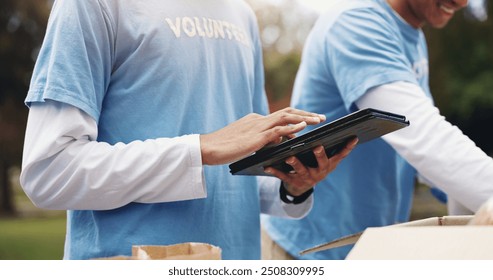 Tablet, volunteer and hands of people in park for charity event, community service or teamwork. Volunteering, ngo group and men and women on digital tech for social media, checklist or online website - Powered by Shutterstock