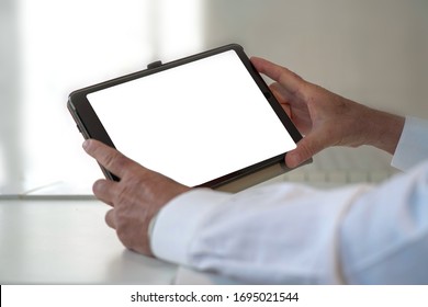 tablet with white space to insert customization held by man in white coat. Doctor or manager shows data to the patient. Business data.