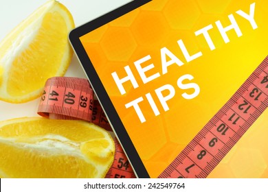 Tablet With Words Healthy Tips And Measuring Tape 