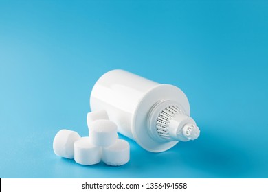 The tableted salt for the system of filtration of water on a blue background