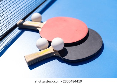 Tabletennis or ping pong rackets and balls on table. Sport concept.