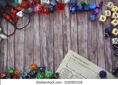 Tabletop Role Playing Flat Lay Background With Colorful RPG Dices And Character Sheet On Wooden Desk