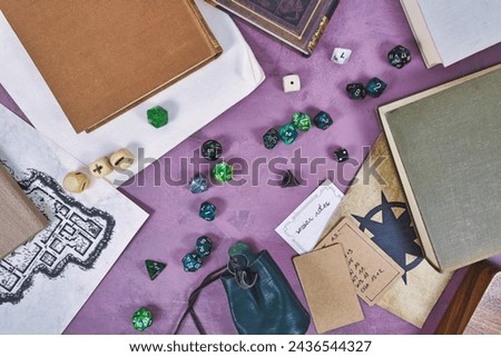 Tabletop role playing flat lay background with colorful RPG dices, notes, rule books and dungeon map