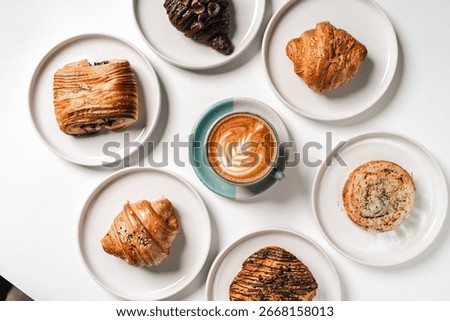 Tabletop view of a spread of pastries and drinks including coffee and juice