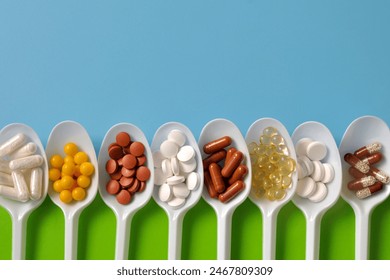 Tablets, capsules, dietary supplements, vitamins on spoons. Medical background - Powered by Shutterstock