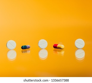 Tablets fall on the table. Slow motion