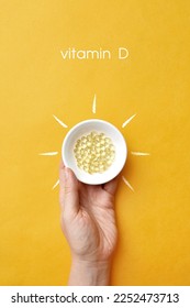 Comprimidos sobre una placa dentro de una foto del sol y la inscripción: vitamina D