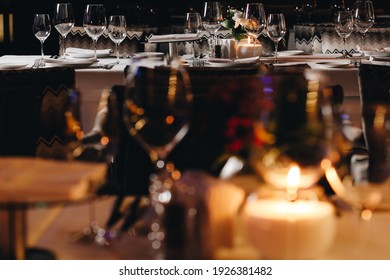 Tableware Glasses, Flower Fork, Knife Served For Dinner In Restaurant With Cozy Interior