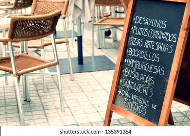 Tabloid Offering Fast Food In An Empty Terrace In San Sebastian, Spain. Vintage Effect Edition.