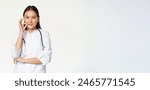 Taboo, medical confidentiality concept. Young asian doctor, female physician showing mouth silence, taboo or zip gesture, promise not tell, standing over white background.