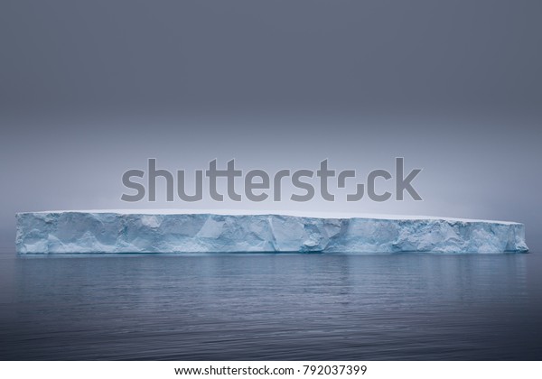 Tabular iceberg in the Antarctic Sound, Antarctica\
during sunset