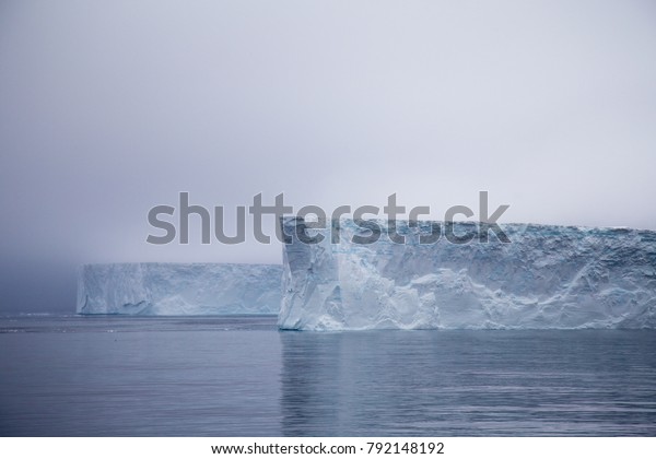 Tabular iceberg in the Antarctic Sound,\
Antarctica during\
sunrise