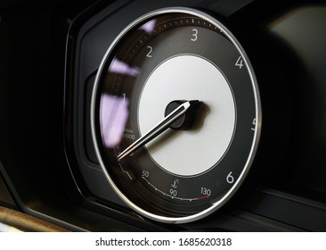Tachometer with integrated temperature sensor on the instrument cluster of a modern luxury car. The arrow indicates zero. New modern luxury cars: sale, repair, spare parts. Concept.