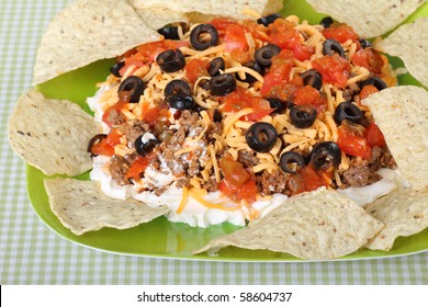 Taco Dip With Tortilla Chips On A Plate