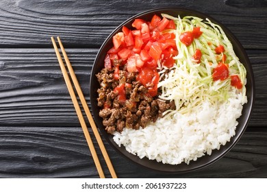 Taco Rice Takoraisu Is A Mexican Japanese Fusion Dish Consisting Of Seasoned Ground Beef, Shredded Lettuce, And Chopped Tomatoes Served Over A Bed Of White Rice Close-up In A Bowl. Horizontal Top View