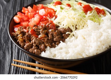 Taco Rice Takoraisu Is A Mexican Japanese Fusion Dish Consisting Of Seasoned Ground Beef, Shredded Lettuce, And Chopped Tomatoes Served Over A Bed Of White Rice Close-up In A Bowl. Horizontal
