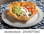 Taco salad with tomatoes, sour cream and guacamole