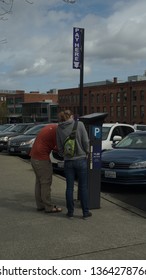 Tacoma WA USA 4/6/2019 A Couple Of People Getting Parking Validation At An Automated Ticket Dispenser, University Of Washington, Tacoma Campus