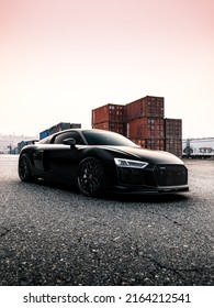 Tacoma, WA, USA
March 3, 2022
Black Audi R8 parked on asphalt with shipping containers in the background
