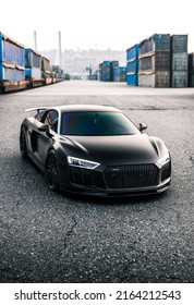 Tacoma, WA, USA
March 3, 2022
Black Audi R8 parked on asphalt with shipping containers in the background
