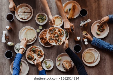 Tacos al Pastor, Group of Mexican People eating in a Taqueria in Mexico, Tacos top view - Powered by Shutterstock