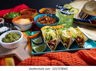 Tacos With All The Trimmings Like Chicken, Beef, Sour Cream And Cheese On A Rustic Background To Be Served In A Restaurant With Sombrero With Margaritas