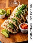 Tacos. Crispy flour and corn tortillas filled with sausage, bacon, beef, cheese, sour cream, salsa and guacamole and served with rice and beans. Classic Tex-Mex or Mexican restaurant entrée favorite.