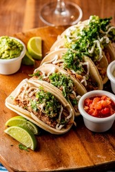 Tacos. Crispy Flour And Corn Tortillas Filled With Sausage, Bacon, Beef, Cheese, Sour Cream, Salsa And Guacamole And Served With Rice And Beans. Classic Tex-Mex Or Mexican Restaurant Entrée Favorite.