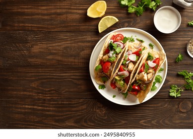 Tacos with vegetables and meat on white plate over wooden background with free space. Top view, flat lay - Powered by Shutterstock