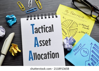 Tactical Asset Allocation (TAA) Text On Notepad With Notes And Charts In The Office. Financial Planning Investment Concept.