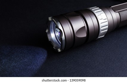 Tactical Flashlight On Black Background