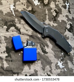 Tactical knife and lighter in a camouflage background