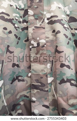 Tactical multicam print on a jacket or uniform, textile industry and army equipment concept.  Close-up of durable camouflage fabric with multicam pattern for tactical gear.