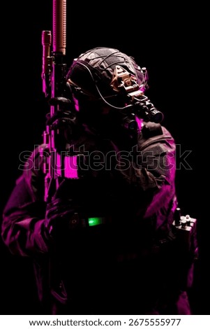 A tactical operator equipped with advanced gear and weaponry, illuminated by striking pink lighting against a dark background. The image highlights themes of readiness, technology, and dedication.