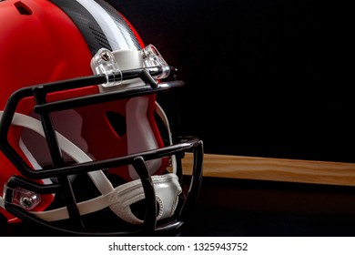 Tactical training, planning for a tough competition and studying the rival team concept theme with close up on a american football helmet next to a blank blackboard with copy space - Powered by Shutterstock