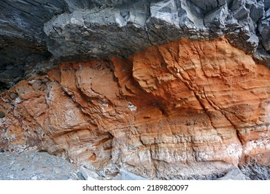 Taeha-ri, Ulleung-gun, Gyeongsangbuk-do, South Korea - February 27, 2022: Winter View Of Red Rock Layers Between Black Volcanic Rocks In The Cave
