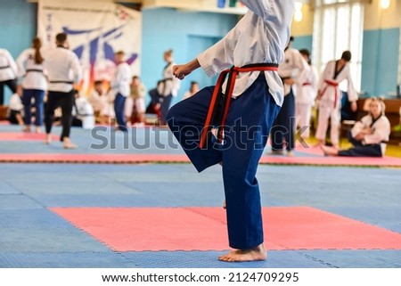 Taekwondo kids athlete. Performing an exercise during a children's taekwondo tournament.