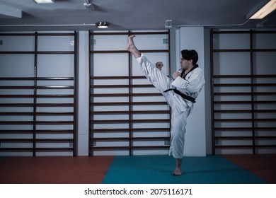 A Taekwondo Master Training In A Gym.