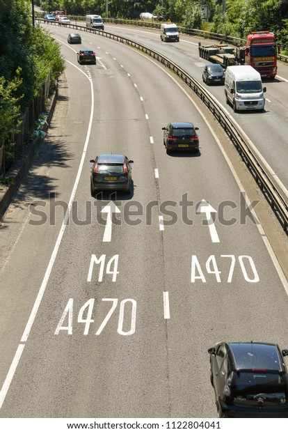Taffs Well, near Cardiff - June 2018: View looking\
down onto the A470 trunk road at Taffs Well heading south towards\
Cardiff. Lane markings show motorists the correct lane to choose\
for the M4