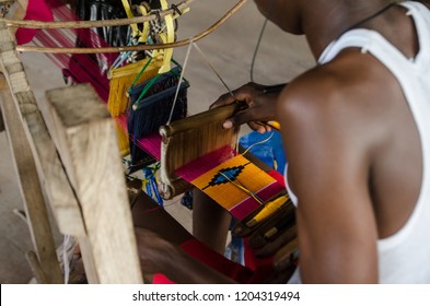 Tafi Abuife Kente Village, Volta Region, Ghana - September the 17th 2018. Locals weaving a traditional kente cloth in a workshop.