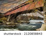 The Taftsville Bridge is a timber-framed covered bridge which spans the Ottauquechee River in the Taftville village of Woodstock, Vermont in the United States.