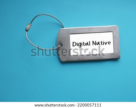 Tag card holder on blue background with text title DIGITAL NATIVE, person who has grown up in digital technology or information age, familiar to language of computers, vdo games and Internet