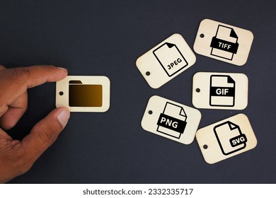 Tag wood with icons of 5 types of image files namely JPEG, PNG, GIF, TIFF and SVG. The concept of saving files in the form of an image - Shutterstock ID 2332335717