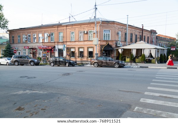 TAGANROG,
RUSSIA - June 20, 2017: City street of Taganrog with modern cars
and old town brick houses in the summer 

