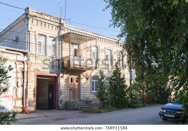 TAGANROG,\
RUSSIA - June 20, 2017: City street of Taganrog with modern cars\
and old town brick houses in the summer  \
